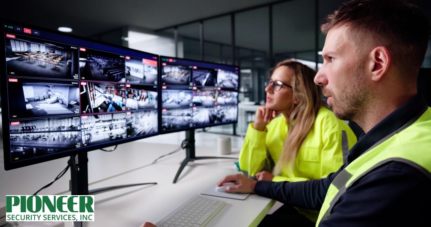 Security operators using control room software to view live feeds from multiple surveillance cameras on dual monitors